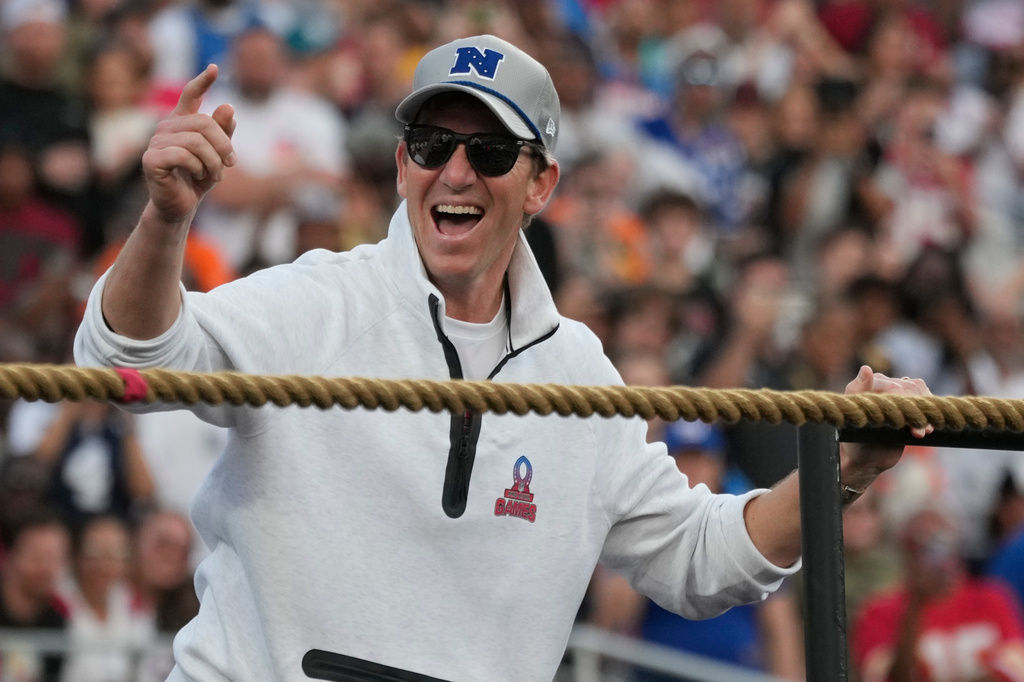 FILE - NFC coach Eli Manning cheers on his players during the tug of war event at the NFL Pro Bowl football game in Orlando, Fla., Feb. 2, 2025. (AP Photo/John Raoux, File)