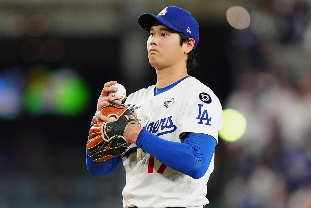 Los Angeles Dodgers pitcher Shohei Ohtani (17) reacts after giving up a double during seventh inning Game 4 World Series playoff MLB baseball action against the Toronto Blue Jays in Los Angeles on Tuesday, Oct. 28, 2025. (Frank Gunn/The Canadian Press via AP)