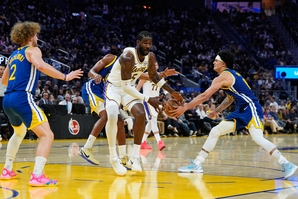 Golden State Warriors forward Gui Santos (15), right, knocks the ball away from Los Angeles Lakers center Deandre Ayton (5) during the first half of an NBA basketball game, Saturday, Feb. 28, 2026, in San Francisco. (AP Photo/Godofredo A. Vásquez)