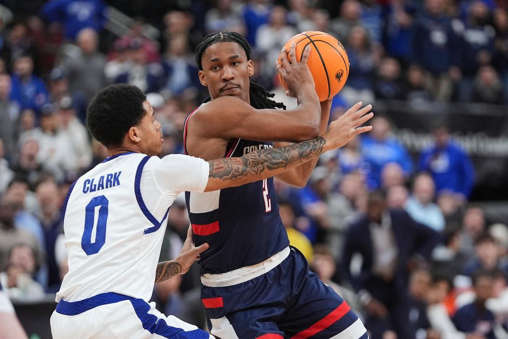 Seton Hall's Adam Clark (0) defends UConn's Silas Demary Jr. (2) during the first half of an NCAA basketball game Tuesday, Jan. 13, 2026, in Newark, N.J. (AP Photo/Frank Franklin II)