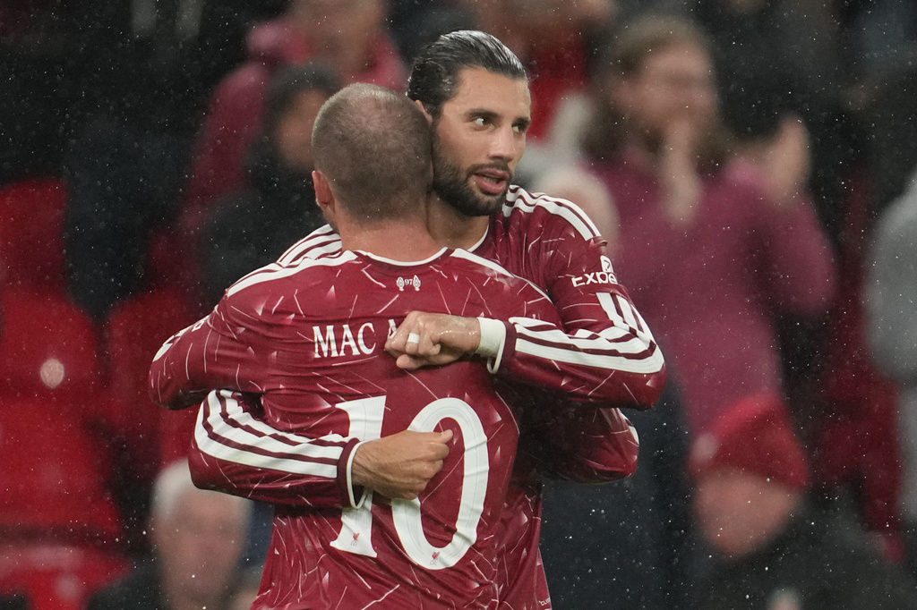 Liverpool's Alexis Mac Allister and Dominik Szoboszlai celebrate after the thrid goal during the third-round English Football League soccer match between Liverpool and Tottenham in Liverpool, England, Tuesday Sept. 15, 2026. (AP Photo/Jon Super)