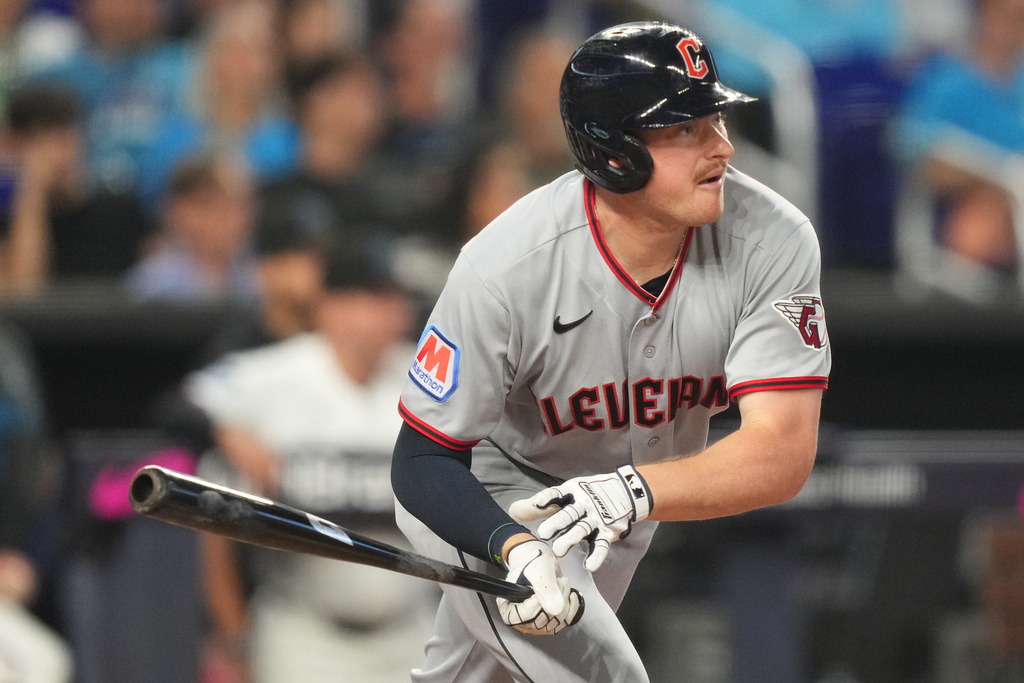 Cleveland Guardians' Kyle Manzardo (9) hits a single during the fifth inning of a baseball game against the Miami Marlins, Saturday, July 11, 2026, in Miami. (AP Photo/Jim Rassol)