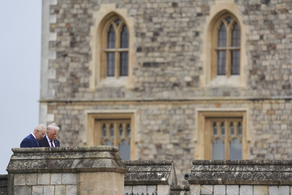 President Donald Trump and Britain's King Charles III walk together as they arrive for a Beating Retreat musical performance on the East Lawn of Windsor Castle, in Windsor, England, Wednesday, Sept. 17, 2025. (AP Photo/Evan Vucci)
