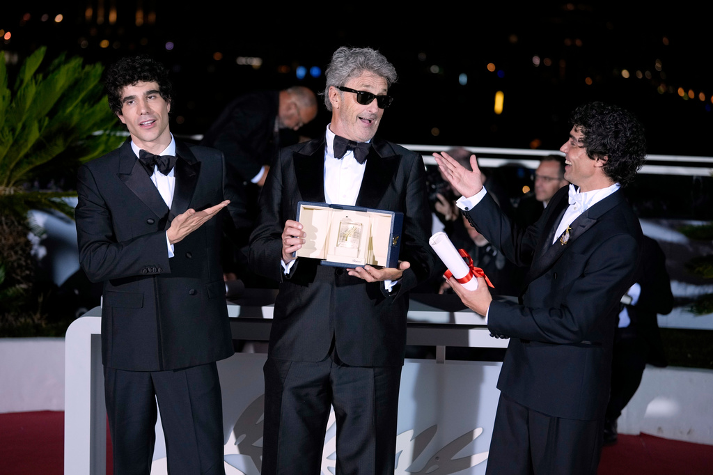 Paweł Pawlikowski, center, winner of the award for best director for 'Fatherland,' poses with Javier Calvo, left, and Javier Ambrossi, winners of the award for best director for 'La bola negra,' at the awards ceremony photo call during the 79th international film festival, Cannes, southern France, Saturday, May 23, 2026. (AP Photo/John Locher)