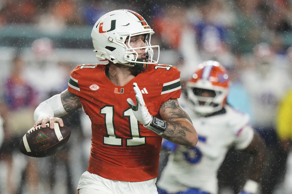 Miami quarterback Carson Beck (11) looks to pass the ball during the first half of an NCAA college football game against Florida, Saturday, Sept. 20, 2025, in Miami Gardens, Fla. (AP Photo/Lynne Sladky)