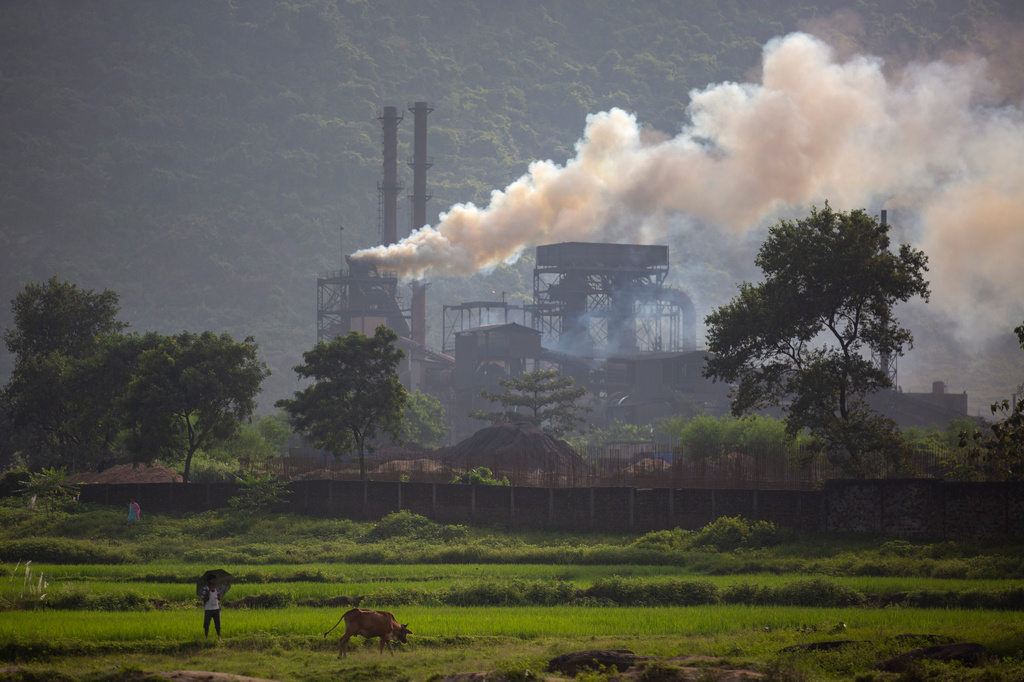 FILE- Smoke rises from a coal-powered steel plant at Hehal village near Ranchi, India, in eastern state of Jharkhand, Sept. 26, 2021. (AP Photo/Altaf Qadri, File)