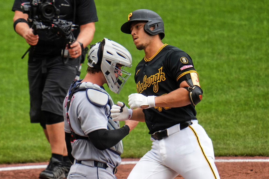 Pittsburgh Pirates' Rafael Flores Jr., right, crosses home plate past Detroit Tigers catcher Dillon Dingler after hitting a solo home run during the seventh inning of a baseball game in Pittsburgh, Wednesday, Aug. 19, 2026. (AP Photo/Gene J. Puskar)