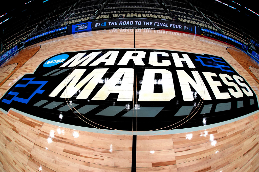 FILE - March Madness logo sis displayed at center court during the opening rounds of the NCAA college basketball tournament in Pittsburgh, Wednesday, March 20, 2024. (AP Photo/Gene J. Puskar, File)