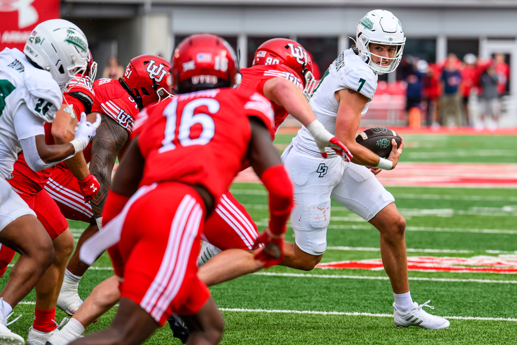 Cal Poly quarterback Ty Dieffenbach (7) runs the ball as he is pursued by the Utah defensive line during an NCAA college football game Saturday, Sept. 6, 2025, in Salt Lake City, Utah. (AP Photo/Tyler Tate)