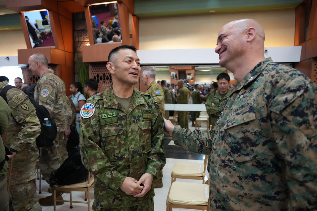 Japan army Maj. Gen. Toshikatsu Musha, left, talks with a U.S. marines after the opening ceremonies of the joint military exercise dubbed "Balikatan" or "Shoulder to Shoulder," Monday, April 20, 2026, in Quezon city, Philippines. (AP Photo/Aaron Favila)