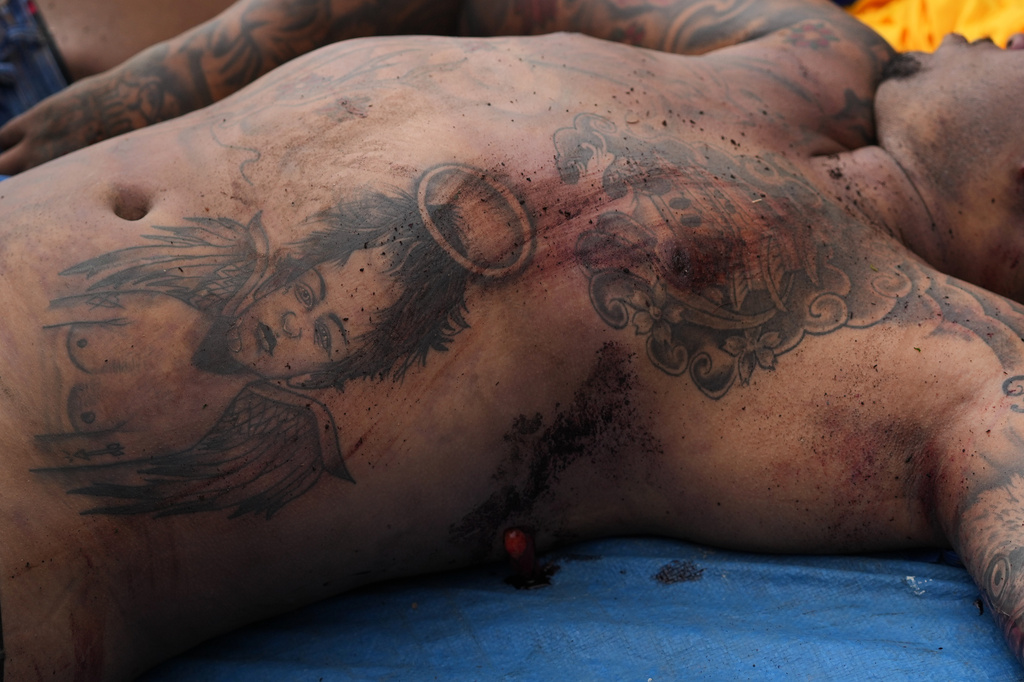 A man killed the day before during a police raid targeting the Comando Vermelho gang lies in the Complexo da Penha favela of Rio de Janeiro, Brazil, Wednesday, Oct. 29, 2025. (AP Photo/Silvia Izquierdo)