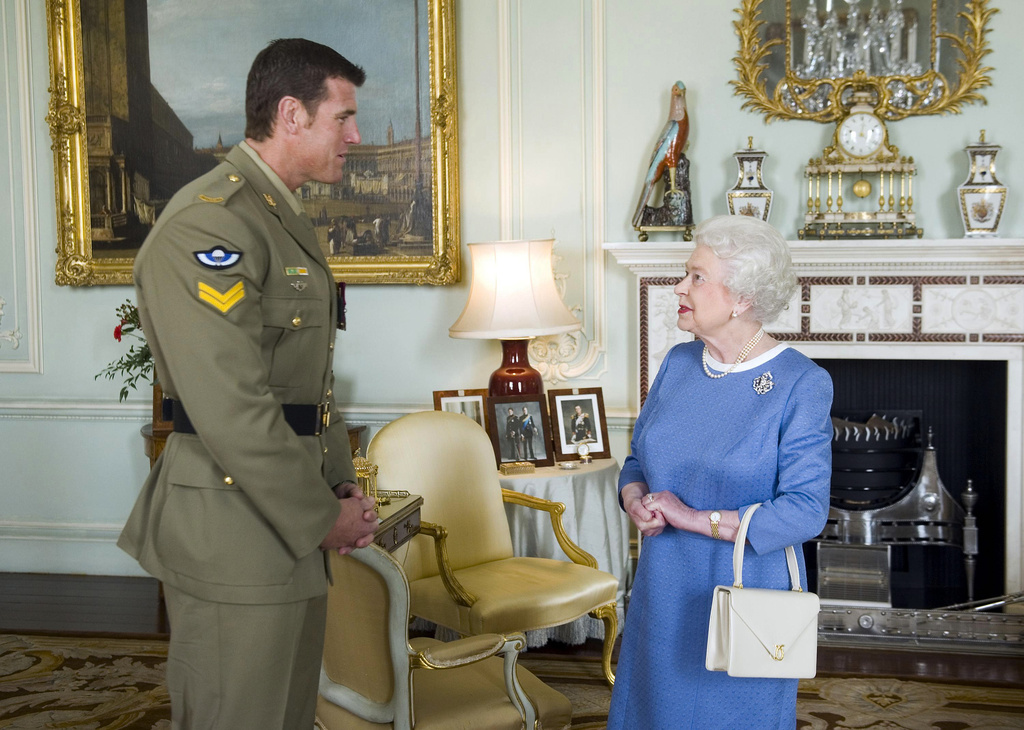 FILE - Britain's Queen Elizabeth II greets Corp. Ben Roberts-Smith from Australia, who was recently awarded the Victoria Cross, during an audience at Buckingham Palace in London, Nov. 15, 2011. (Anthony Devlin/Pool via AP, File)