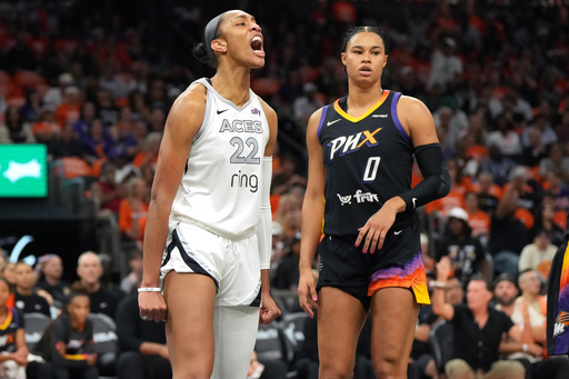 Las Vegas Aces center A'ja Wilson (22) reacts after scoring on Phoenix Mercury forward Satou Sabally during the first half of Game 3 of the WNBA basketball finals, Wednesday, Oct. 8, 2025, in Phoenix. (AP Photo/Rick Scuteri) Las Vegas Aces center A'ja Wilson (22) reacts after scoring on Phoenix Mercury forward Satou Sabally during the first half of Game 3 of the WNBA basketball finals, Wednesday, Oct. 8, 2025, in Phoenix. (AP Photo/Rick Scuteri)