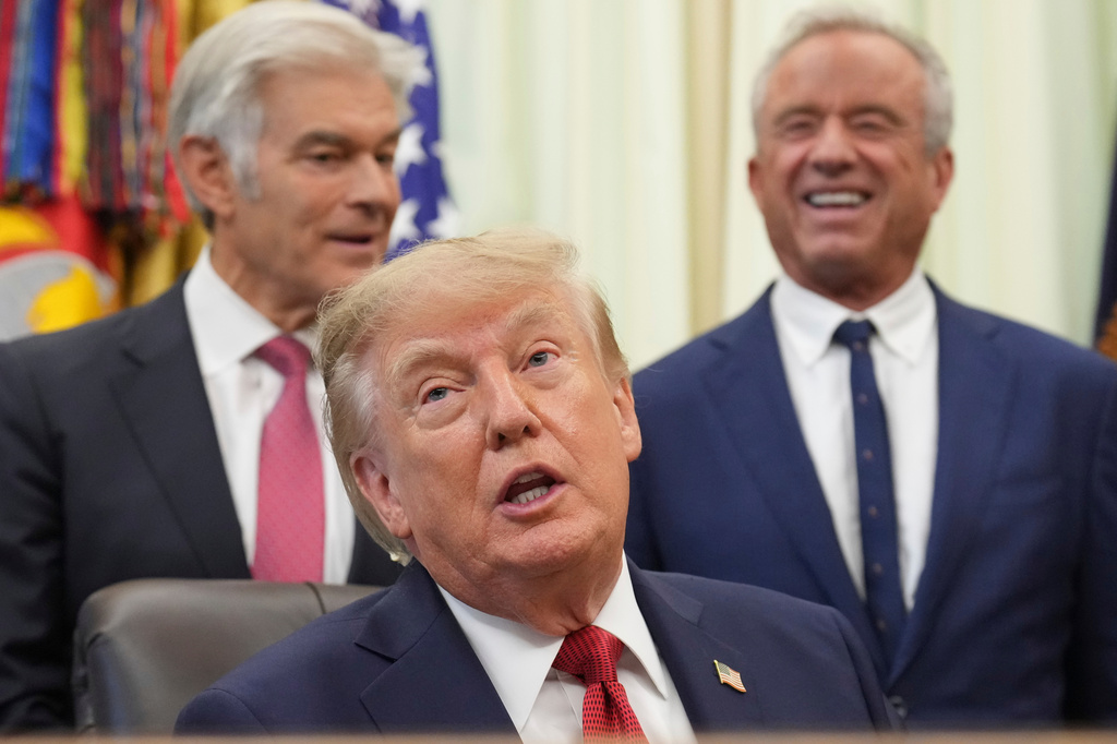 President Donald Trump speaks as Mehmet Oz, administrator of the Centers for Medicare & Medicaid Services,, left, and Health and Human Services Secretary Robert F. Kennedy Jr. listen during an event about healthcare in the Oval Office of the White House, Friday Sept. 18, 2026, in Washington. (AP Photo/Jacquelyn Martin)