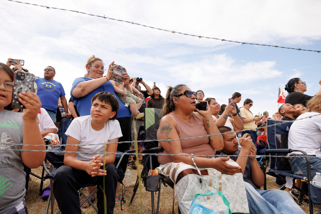 Spectators watch the charging event during festivities to commemorate the 150th anniversary of the Battle of the Little Bighorn in Crow Agency, Mont., on Thursday, June 25, 2026. (AP Photo/Tailyr Irvine)