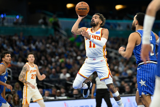 Atlanta Hawks guard Trae Young (11) goes up to shoot in front of Orlando Magic guard Tyus Jones (2) during the first half of an NBA basketball game Friday, Oct. 24, 2025, in Orlando, Fla. (AP Photo/Phelan M. Ebenhack) Atlanta Hawks guard Trae Young (11) goes up to shoot in front of Orlando Magic guard Tyus Jones (2) during the first half of an NBA basketball game Friday, Oct. 24, 2025, in Orlando, Fla. (AP Photo/Phelan M. Ebenhack)