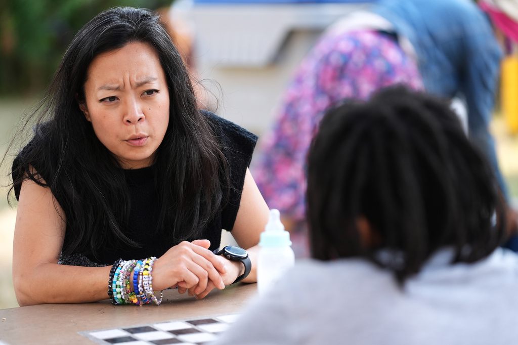 Democratic gubernatorial candidate Francesca Hong talks with a Milwaukee resident during "We Outside" Annual Community Event at Metcalfe Park Rising, Friday, July 24, 2026, in Milwaukee. (AP Photo/Nam Y. Huh)