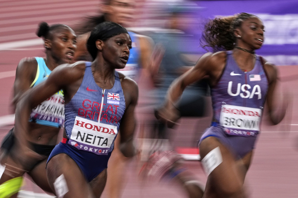 Britain's Daryll Neita and United States' Brittany Brown compete in a women's 200 meters heat at the World Athletics Championships in Tokyo, Wednesday, Sept. 17, 2025. (AP Photo/Hiro Komae)