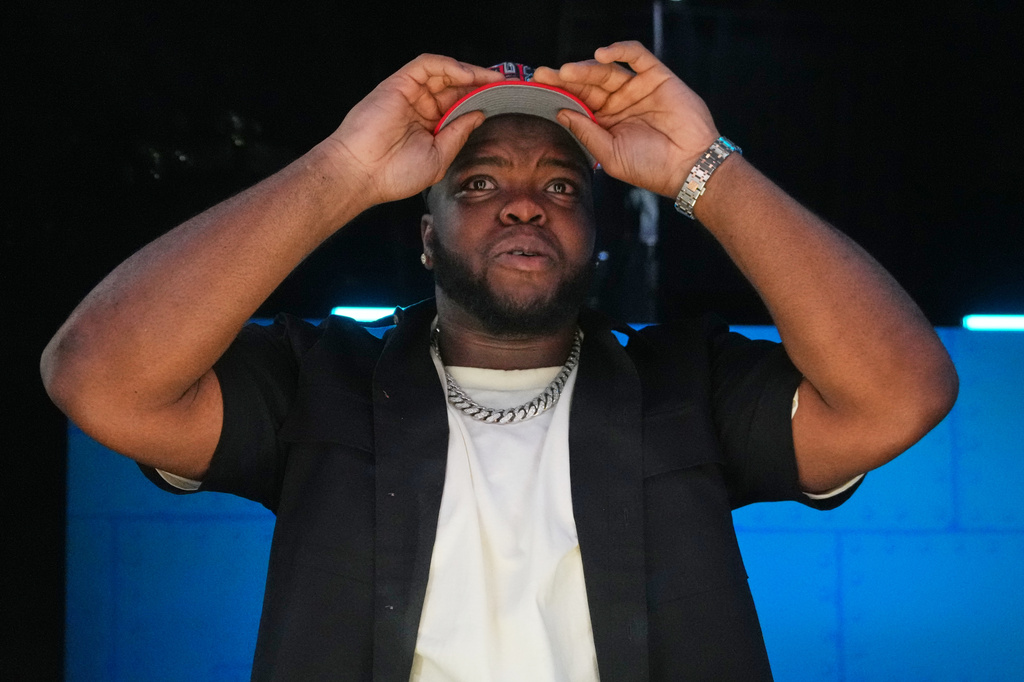 Ohio State defensive lineman Kayden McDonald puts on a hat after being chosen by the Houston Texans with the 36th overall pick during the second round of the NFL football draft, Friday, April 24, 2026, in Pittsburgh. (AP Photo/Jeff Roberson)