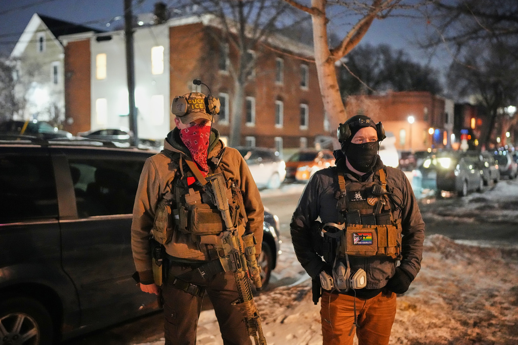 EDS NOTE: OBSCENITY - Armed community response members patrol near the scene where 37-year-old Alex Pretti was fatally shot by a U.S. Border Patrol officer earlier in the day, Saturday, Jan. 24, 2026, in Minneapolis. (AP Photo/Adam Gray)