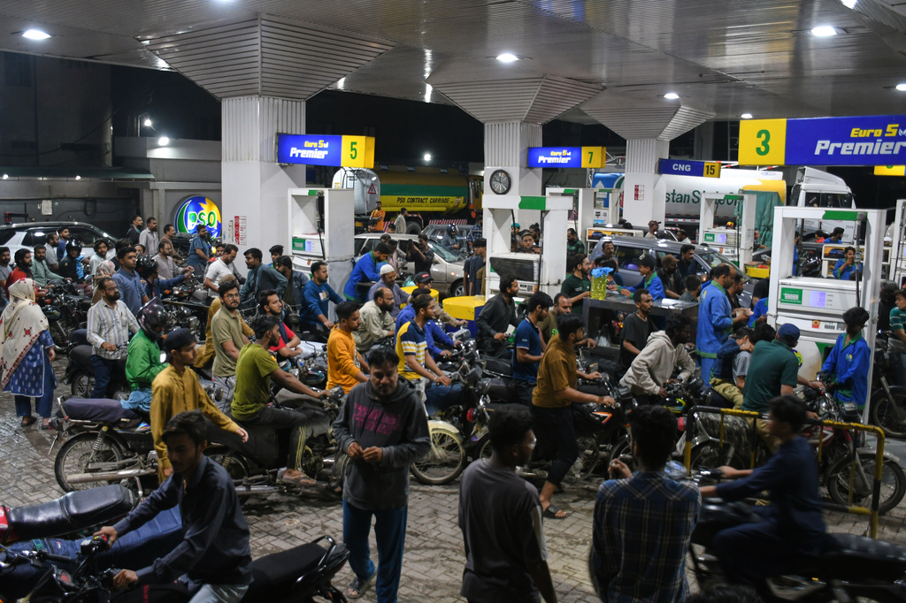 Motorcyclists crowd into a filling station as they wait their turn to buy fuel, in Karachi, Pakistan, Thursday, April 2, 2026. (AP Photo/Ali Raza)