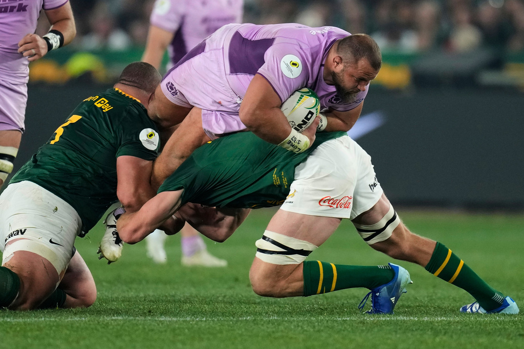 Scotland's Pierre Schoeman, top, is tackled by South Africa's captain Pieter-Steph du Toit, right, and his teammate Wilco Louw during the Nations Championship Test rugby match between South Africa and Scotland, in Pretoria, Saturday, July 11, 2026. (AP Photo/Themba Hadebe)