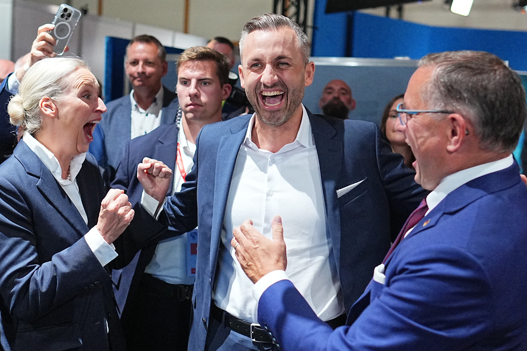 Ulrich Siegmund, center, lead candidate and co-chair of the AfD state parliamentary group in Saxony-Anhalt, celebrates with Alice Weidel, federal chairwoman and co-chair of the AfD parliamentary group in the Bundestag, and Tino Chrupalla, federal chairman and co-chair of the AfD parliamentary group in the Bundestag, after the first results at an election party of the "Alternative for Germany" (AfD) after the Saxony-Anhalt state elections in Magdeburg, eastern Germany, Sunday, Sept. 6, 2026. (Michael Kappeler/dpa via AP)