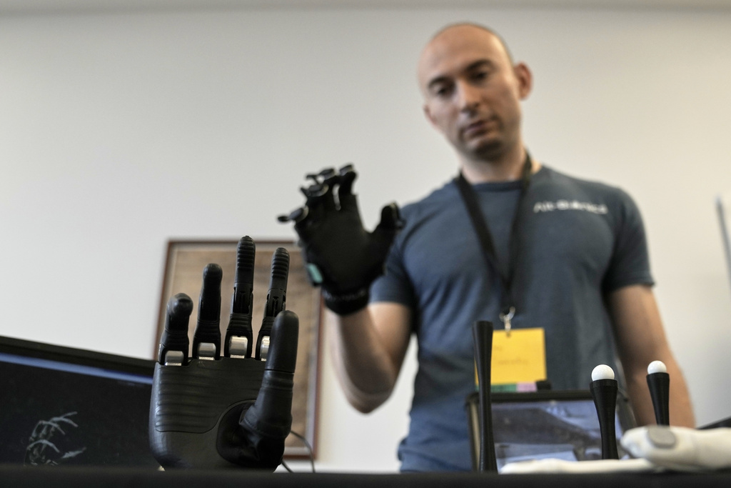 CORRECTS NAME OF COMPANY: Ryan Saavedra, CEO of Alt-Bionics, operates a bionic hand at the first International Humanoid Olympiad at the Olympic Academy, in ancient Olympia, Greece, Monday, Sept. 1, 2025. (AP Photo/Thanassis Stavrakis)
