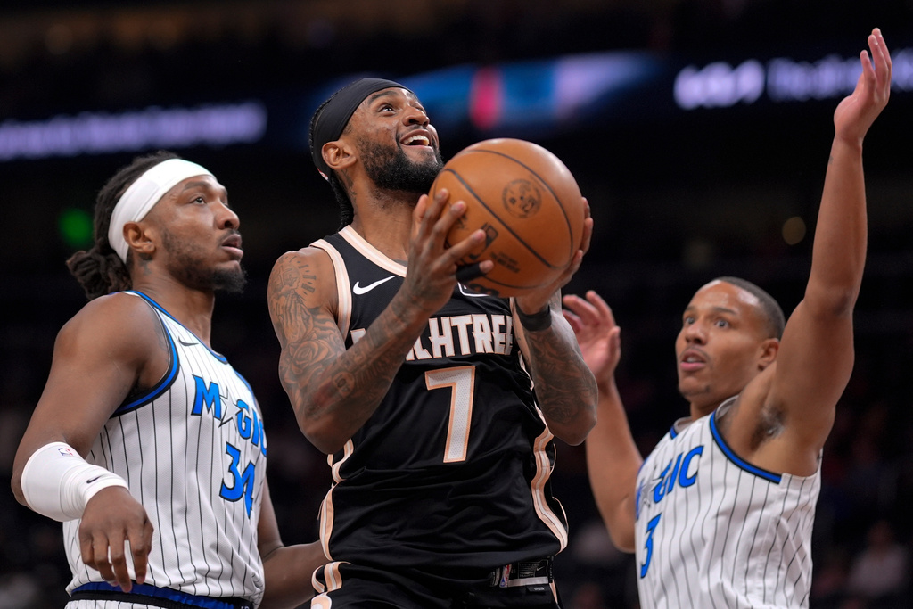 Atlanta Hawks guard Nickeil Alexander-Walker (7) shoots against Orlando Magic guard Desmond Bane (3) during the first half of an NBA basketball game, Monday, March 16, 2026, in Atlanta. (AP Photo/Mike Stewart)
