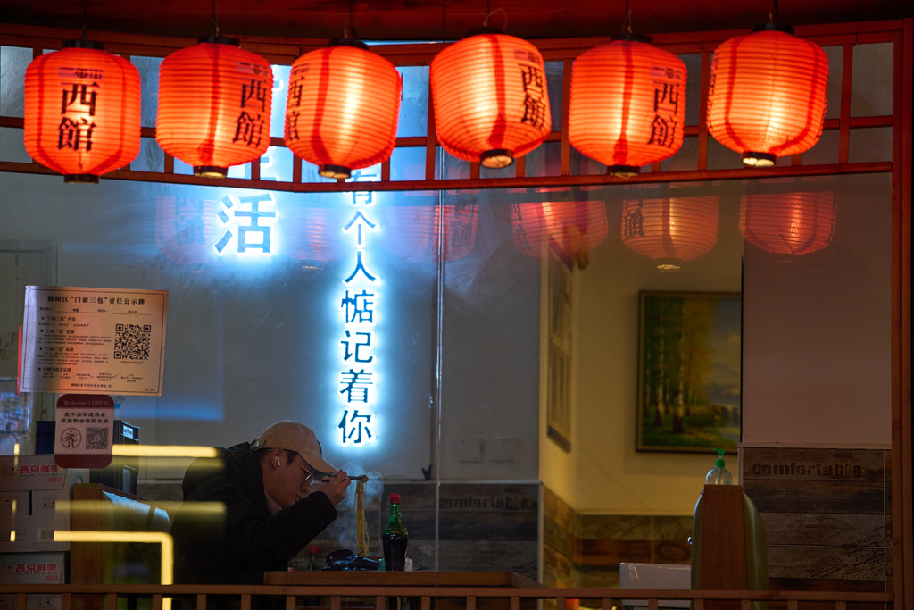 A customer eats noodle at a restaurant in an area known for its Japanese eateries in Beijing, Friday, Jan. 16, 2026. (AP Photo/Ng Han Guan)