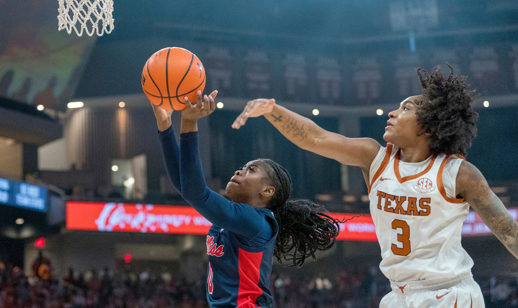 Mississippi guard Sira Thienou (0) goes to the basket as Texas guard Rori Harmon (3) defends during the first half of an NCAA college basketball game in Austin, Texas, Sunday, Jan. 4, 2026. (AP Photo/Rodolfo Gonzalez)