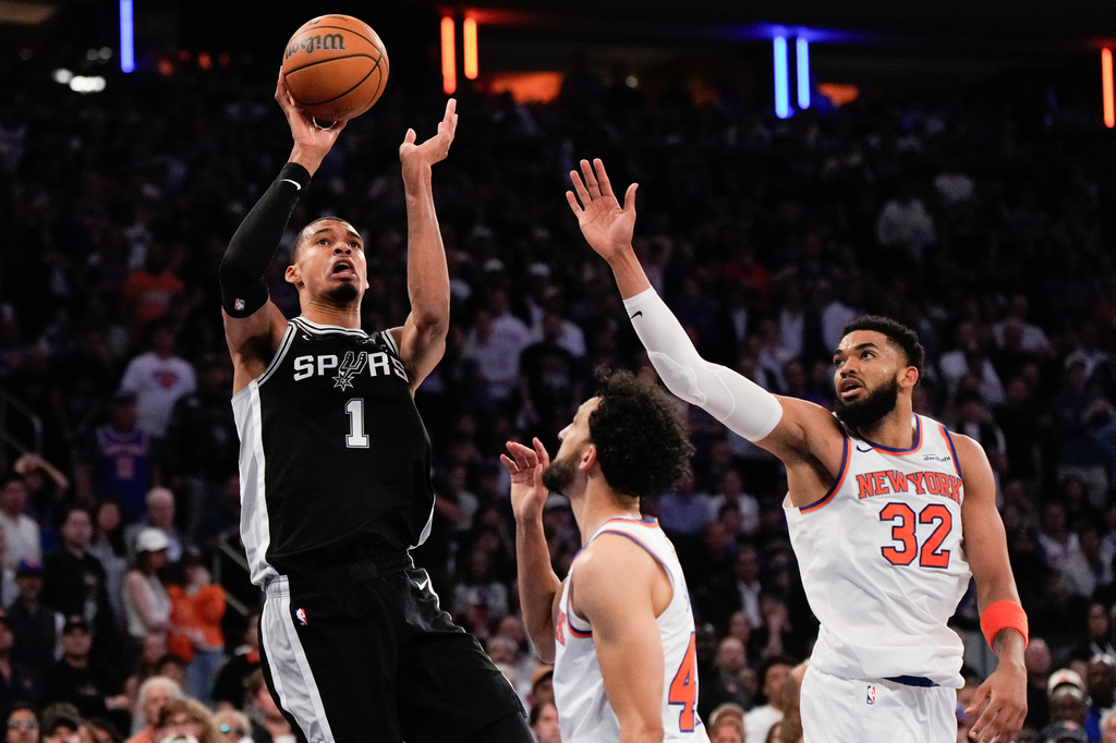 San Antonio Spurs forward Victor Wembanyama (1) shoots over New York Knicks center Karl-Anthony Towns (32) during second half of Game 3 of the NBA Finals basketball series, Monday, June 8, 2026, in New York. (AP Photo/Ross D. Franklin)