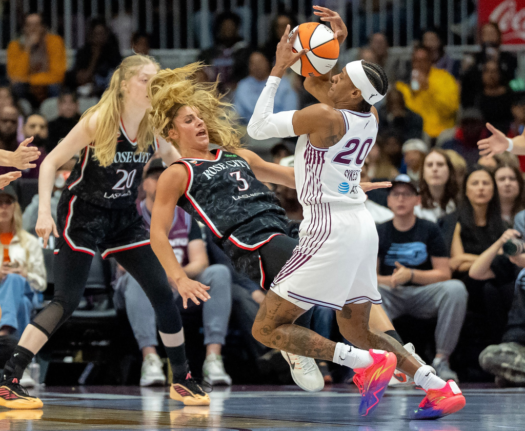 Toronto Tempo guard Brittney Sykes (20) picks up an offensive foul as she drives through Portland Fire guard Sarah Ashlee Barker (3) during the first half of a WNBA basketball game in Toronto, Saturday May 23, 2026. (Frank Gunn/The Canadian Press via AP)