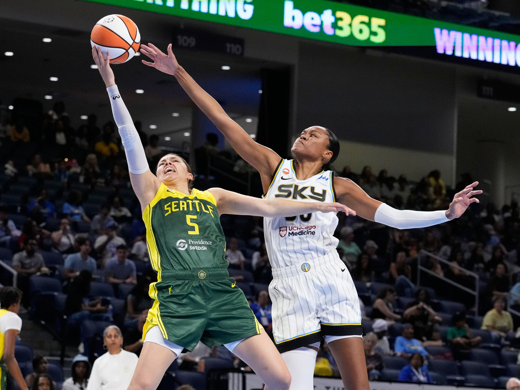 Seattle Storm guard Jade Melbourne, left, drives to the basket past Chicago Sky forward-center Azura Stevens during the first half of a WNBA basketball game Wednesday, July 15, 2026, in Chicago. (AP Photo/Nam Y. Huh)