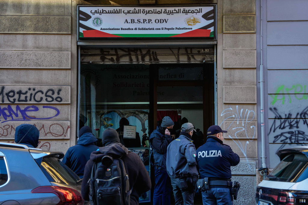 Police officers inspect a charitable association supporting Palestinian civilians in Milan, Italy, Saturday, Dec. 27, 2025 after Italian investigators have arrested nine people suspected of raising millions of euros for Hamas. (Claudio Furlan/LaPresse via AP)
