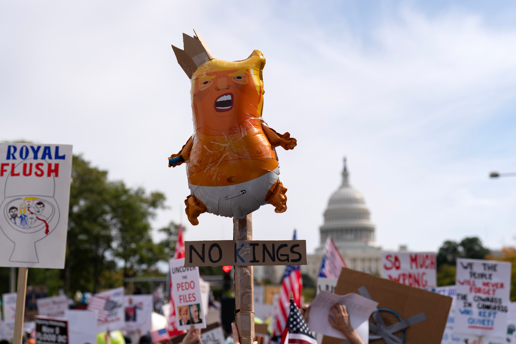 Demonstrators rally on Pennsylvania Avenue during a No Kings protest in Washington, Saturday, Oct. 18, 2025. (AP Photo/Jose Luis Magana)