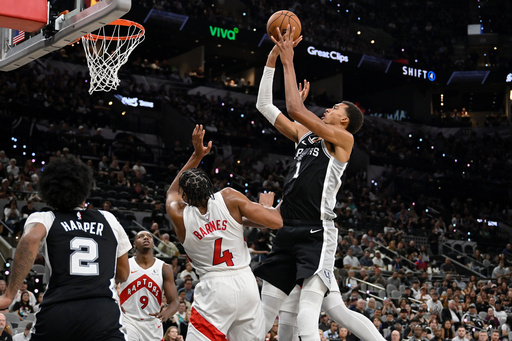 San Antonio Spurs center Victor Wembanyama (1) shoots against Toronto Raptors guard Scottie Barnes (4) during the second half of an NBA basketball game, Monday, Oct. 27, 2025, in San Antonio. (AP Photo/Darren Abate) San Antonio Spurs center Victor Wembanyama (1) shoots against Toronto Raptors guard Scottie Barnes (4) during the second half of an NBA basketball game, Monday, Oct. 27, 2025, in San Antonio. (AP Photo/Darren Abate)