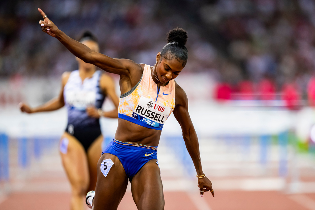 United States' Masai Russell celebrates winning the women's 100-meter hurdles race, setting a new world record, at the Diamond League athletics meeting, Thursday, Aug. 27, 2026, in Zurich, Switzerland. (Jean-Christophe Bott/Keystone via AP)
