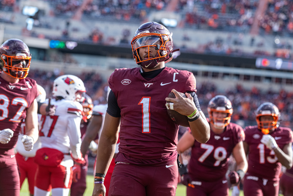 Virginia Tech quarterback Kyron Drones (1) runs in for a touchdown against Louisville during the first half of an NCAA college football game, Saturday, Nov. 1, 2025, in Blacksburg, Va. (AP Photo/Robert Simmons)