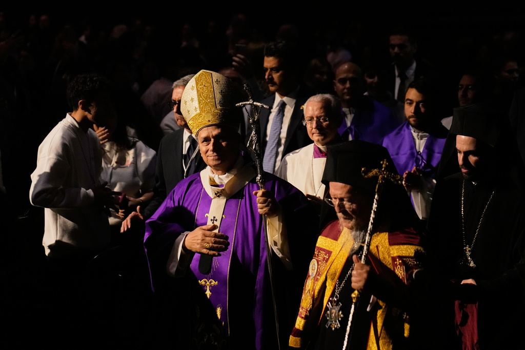 FILE - Pope Leo XIV arrives with Ecumenical Patriarch Bartholomew I, the spiritual leader of the world's Eastern Orthodox Christians, to celebrate a Mass at the Volkswagen Arena in Istanbul, Turkey, Nov. 29, 2025. (AP Photo/Khalil Hamra, File)