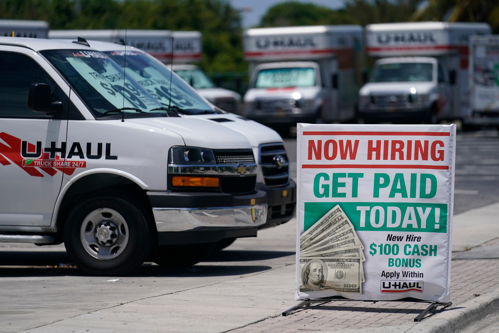 FILE - A sign at a UHaul store looking to hire employees is also offering a bonus, Thursday, May 20, 2021, in Boynton Beach, Fla. (AP Photo/Marta Lavandier, File)
