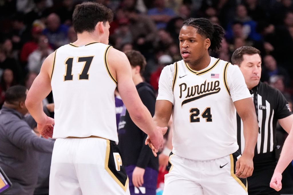 Purdue forward Raleigh Burgess, right, celebrates with guard Omer Mayer after he scored a 3-point basket during the first half of an NCAA college basketball game against Northwestern in the third round of the Big 10 Conference tournament, Thursday, March 12, 2026, in Chicago. (AP Photo/Nam Y. Huh)
