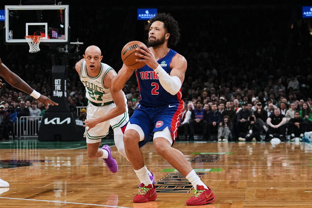 Detroit Pistons guard Cade Cunningham (2) lines up a 3-point shot against Boston Celtics guard Jordan Walsh (27) during the first half of an NBA basketball game, Monday, Dec. 15, 2025, in Boston. (AP Photo/Charles Krupa)