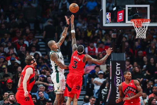 Milwaukee Bucks' Kyle Kuzma (second left) shoots over Toronto Raptors' Brandon Ingram (3) during first half NBA basketball action in Toronto on Friday, October 24, 2025. (Nick Iwanyshyn/The Canadian Press via AP) Milwaukee Bucks' Kyle Kuzma (second left) shoots over Toronto Raptors' Brandon Ingram (3) during first half NBA basketball action in Toronto on Friday, October 24, 2025. (Nick Iwanyshyn/The Canadian Press via AP)