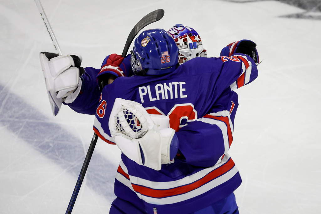 Team USA's Victor Plante celebrates his game-winning goal with goalie Luke Carrithers following overtime CHL-USA Prospects Challenge hockey action against Team CHL in Lethbridge, Alberta, on Wednesday, Nov. 26, 2025. (/Jeff McIntosh/The Canadian Press via AP)