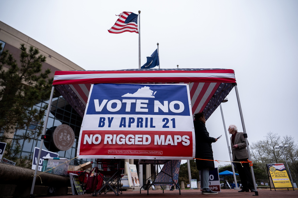 Fairfax County Republican Committee members Harry Lowcock and Esmat Mostafaeithe wait to talk voters outside the Fairfax County Government Center during early voting for the Virginia redistricting referendum Friday, April 3, 2026, in Fairfax, Va. (AP Photo/Julia Demaree Nikhinson)