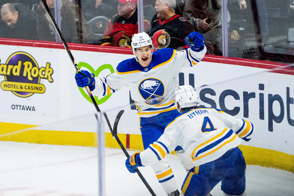 Buffalo Sabres' Bowen Byram (4) celebrates his game-winning goal against the Ottawa Senators with Ryan McLeod (71) in overtime NHL hockey action in Ottawa, on Tuesday, Dec. 23, 2025. (Spencer Colby/The Canadian Press via AP)