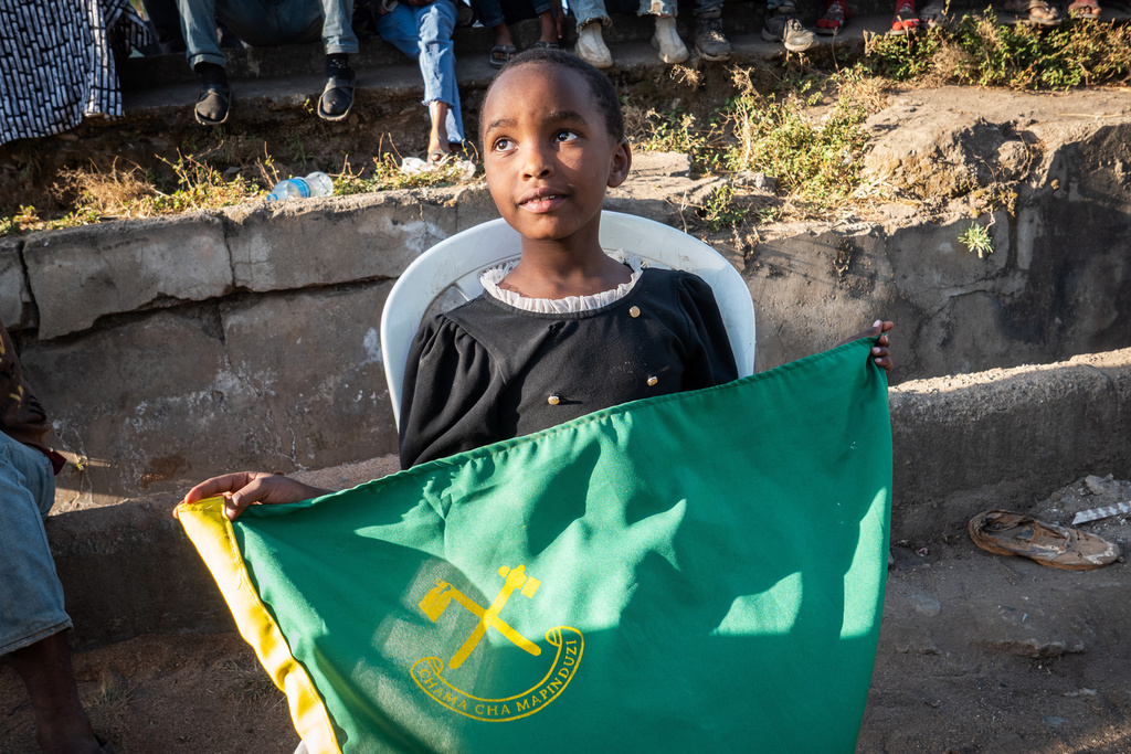 A child holds a flag for Tanzania's ruling Chama Cha Mapinduzi party during a campaign rally in Arusha, Tanzania, Oct. 11, 2025. (AP Photo)