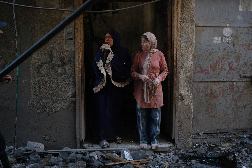 Residents inspect the site of an Israeli airstrike in Gaza city, Saturday, July 18, 2026. (AP Photo/Jehad Alshrafi)