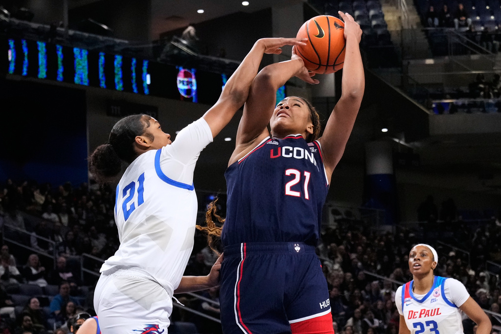 UConn forward Sarah Strong, right, shoots against DePaul guard Natiah Nelson during the first half of an NCAA college basketball game in Chicago, Wednesday, Feb. 4, 2026. (AP Photo/Nam Y. Huh)